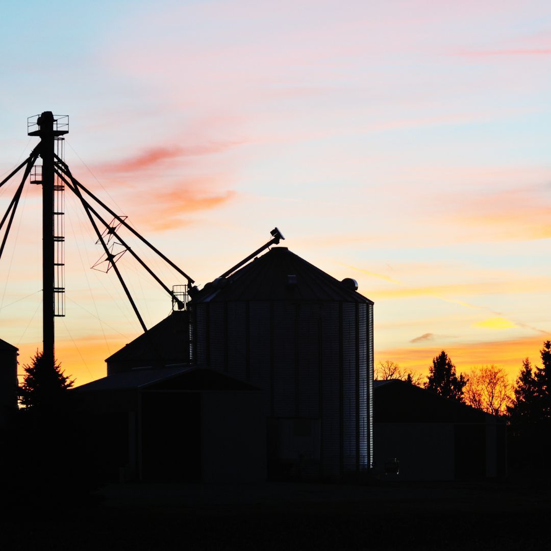 Grain Silo with Grain Dryer in Sunset