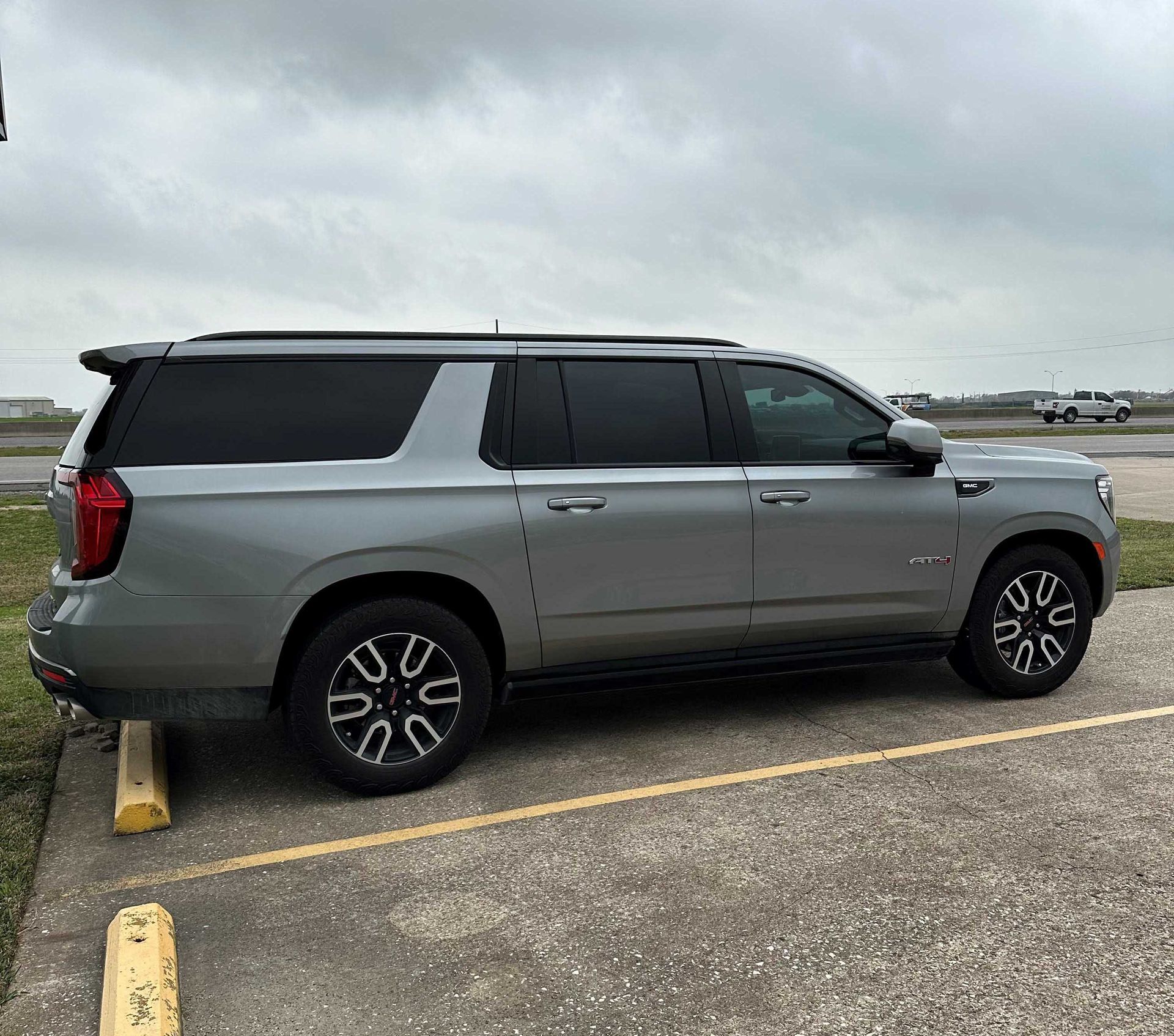 A silver suv is parked in a parking lot.