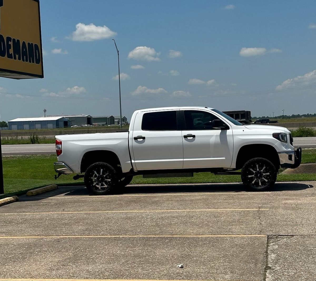 A white truck is parked in a parking lot.