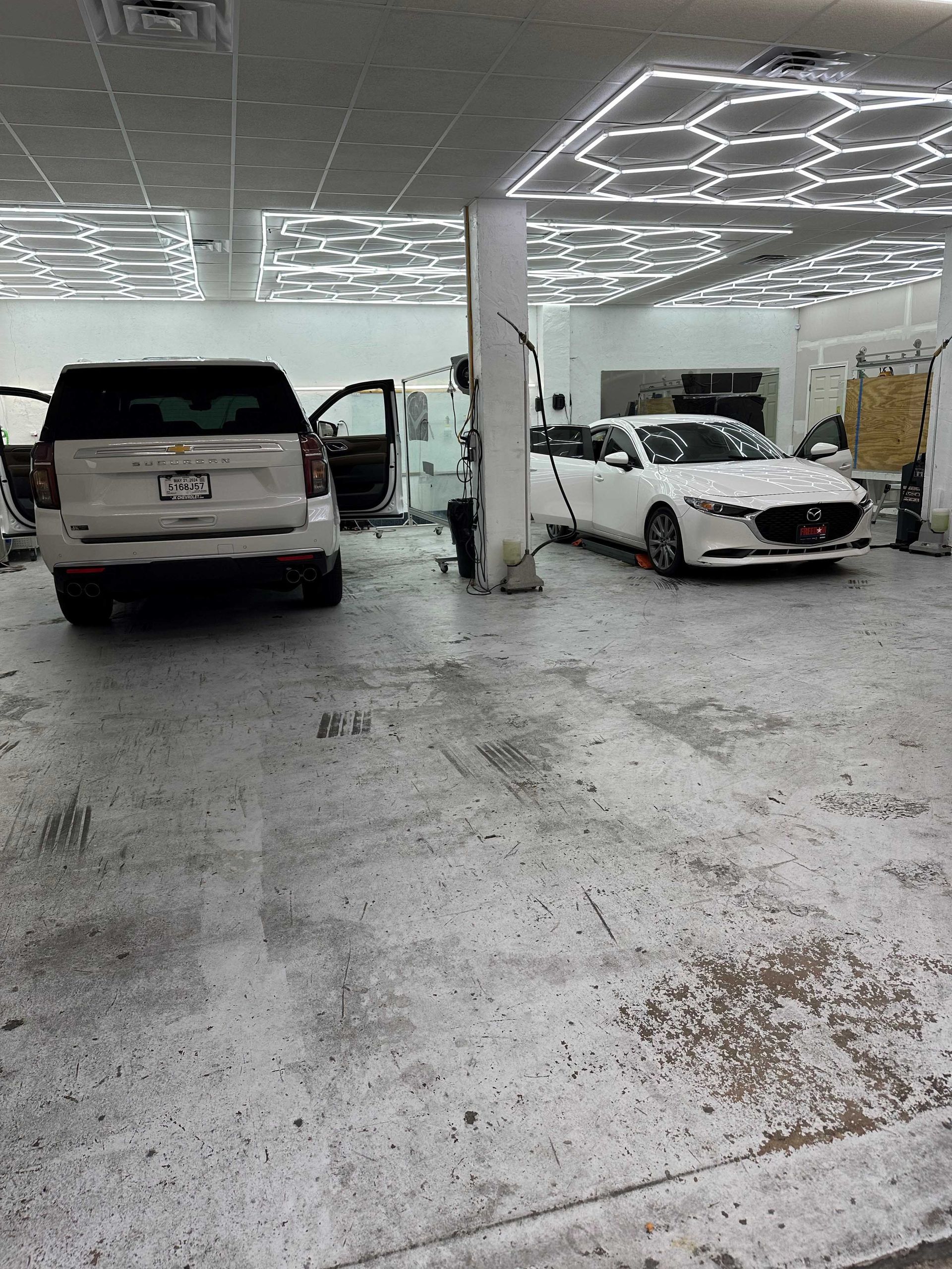 A car is being worked on in a car wash.