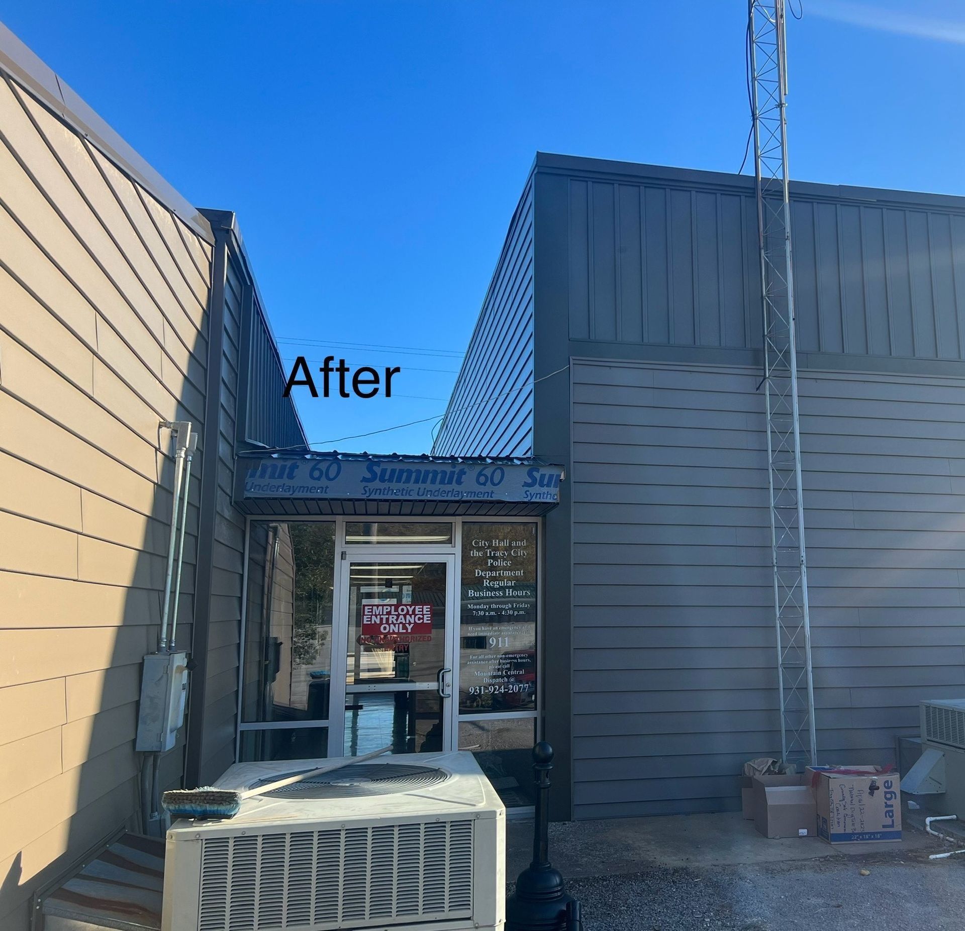 A building entrance with tan siding, a metal roof, and an air conditioner. 