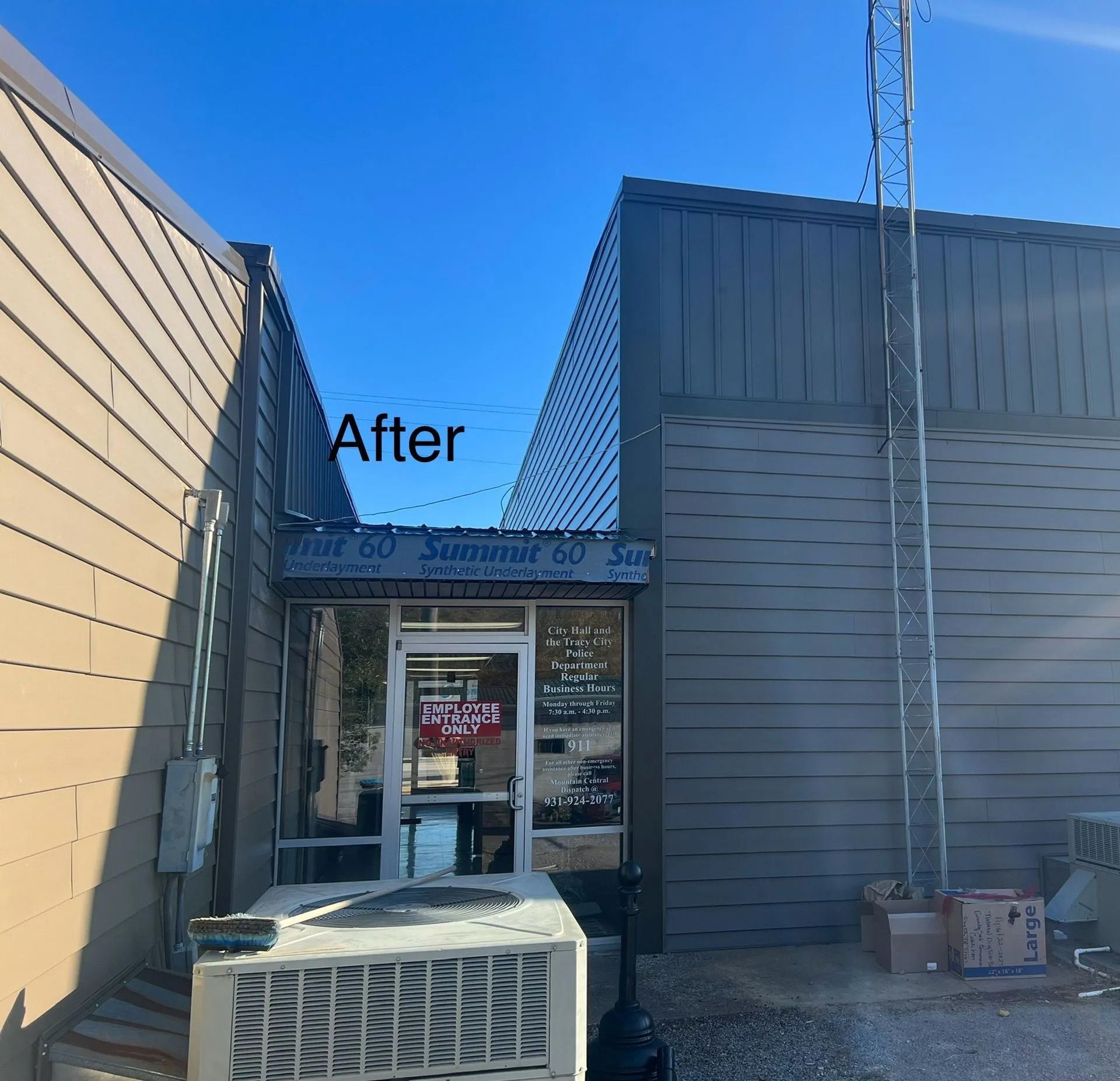 Exterior of a building entrance with “After” sign, gray siding, and blue sky above