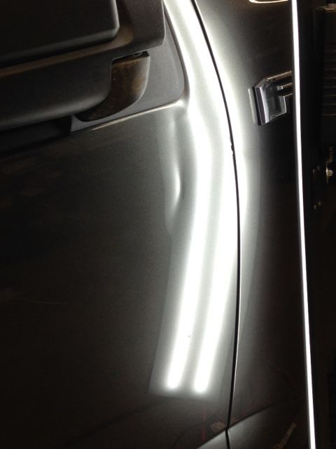 A close up of a car door with the letter f on it