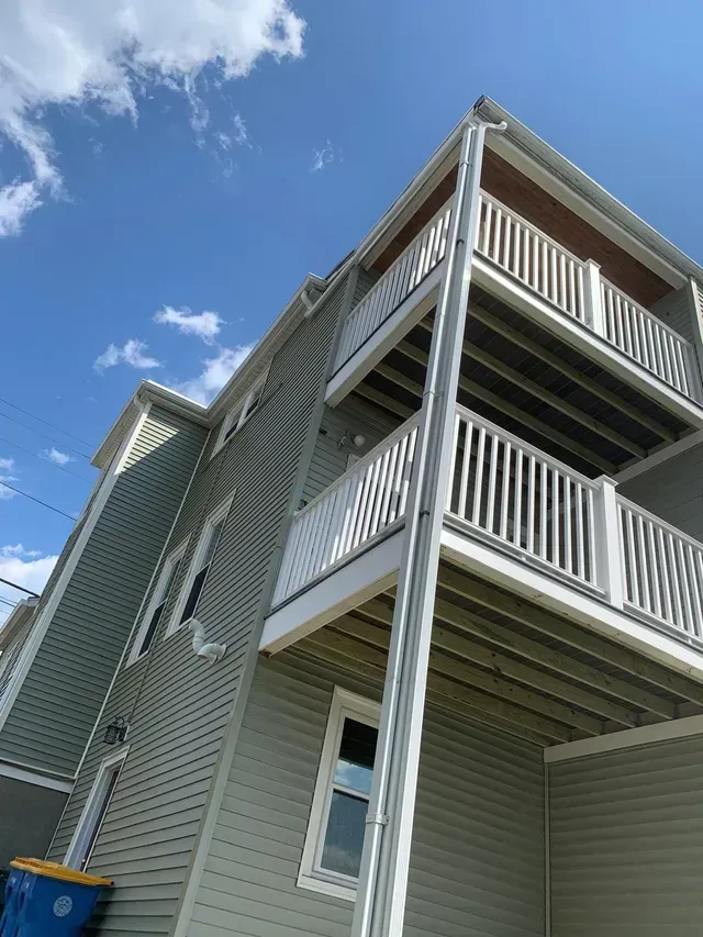 A large house with a lot of windows and balconies on a sunny day.
