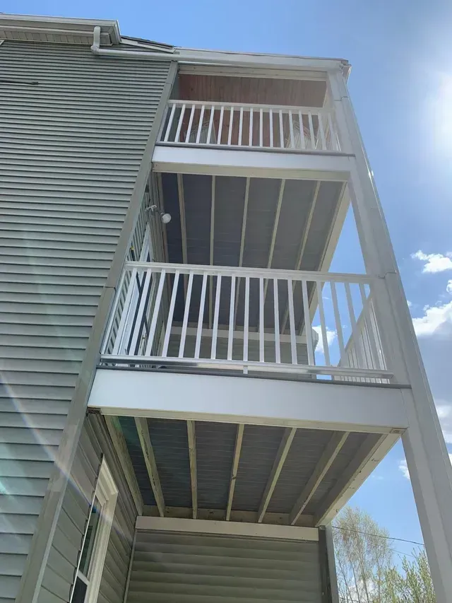 A building with three balconies on the side of it.