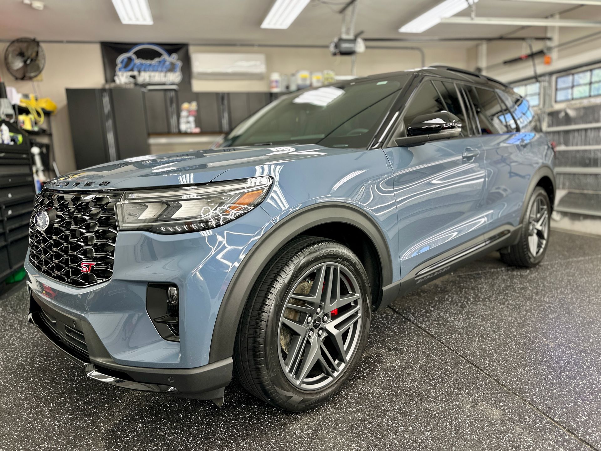 Blue Ford Explorer ST SUV parked in a garage.