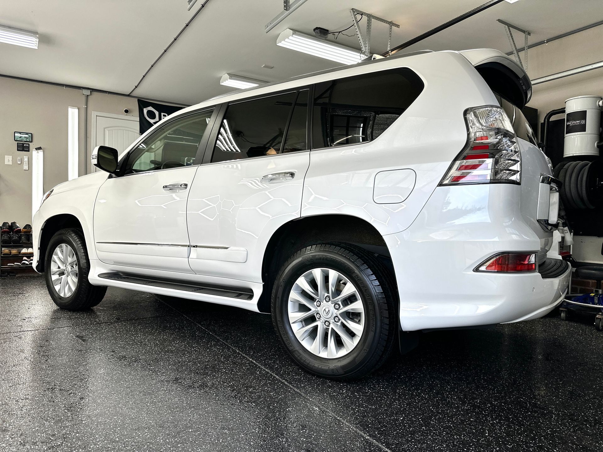 White Lexus SUV parked inside a garage.