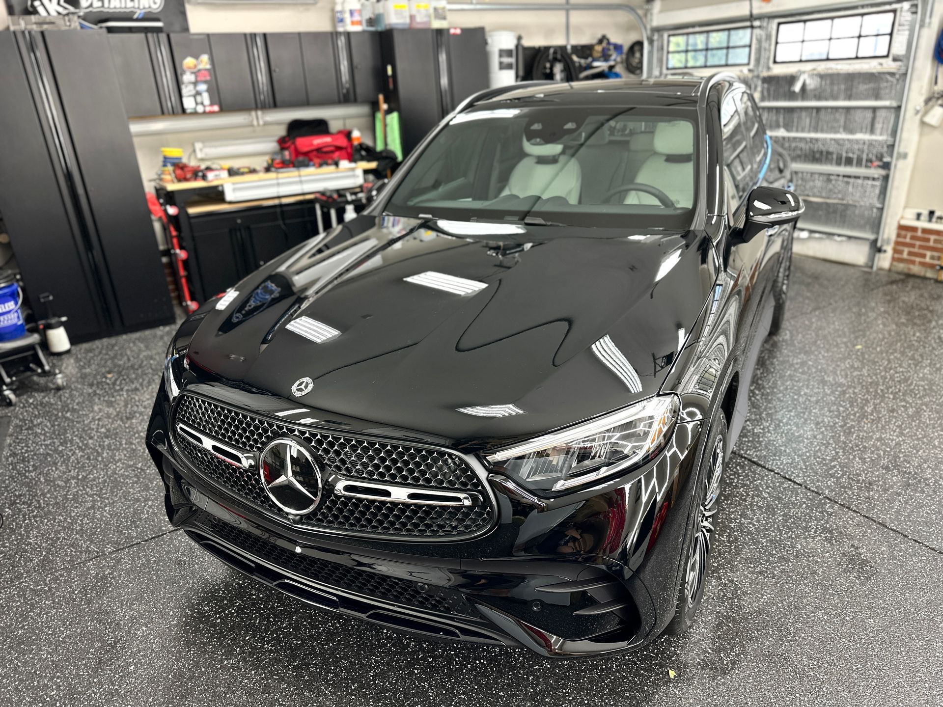 Black Mercedes SUV in a garage with a glossy finish.