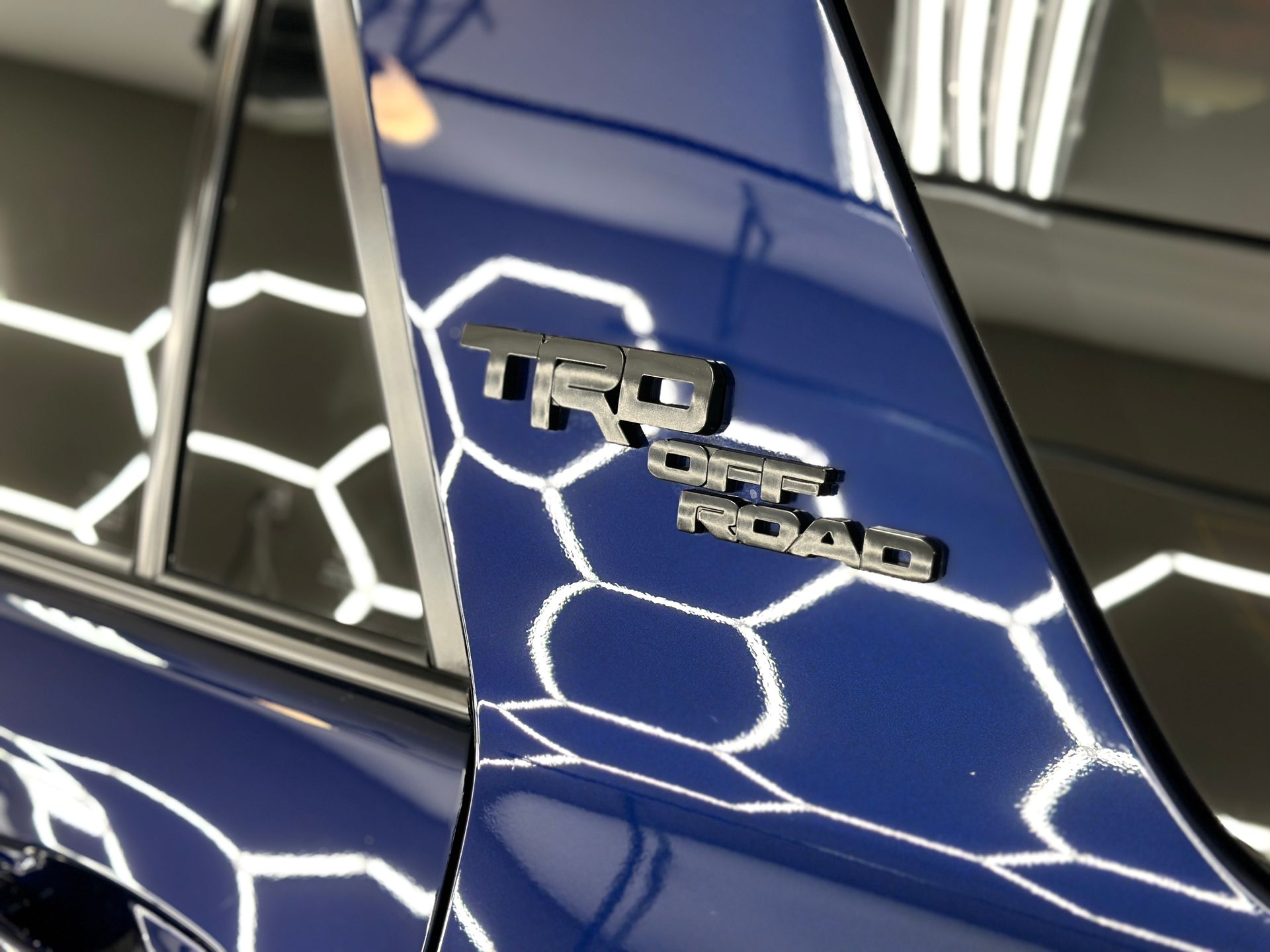 TRD Off Road emblem on a blue vehicle.