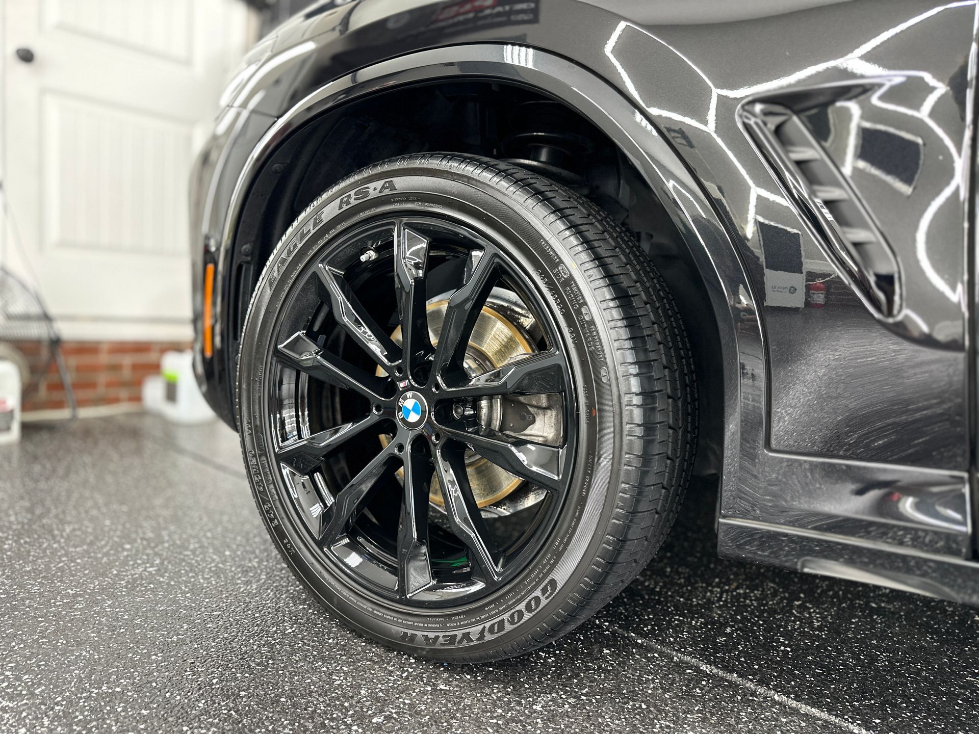 Black BMW car wheel with shiny black rim and tire.