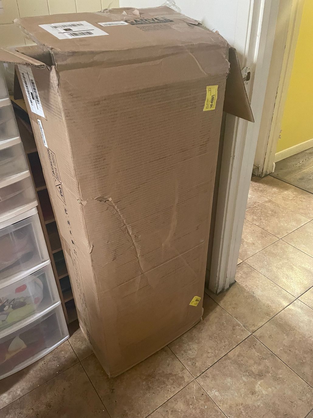 Two children seated at a table, drawing with markers.