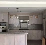 Kitchen with light gray cabinets, stainless steel appliances, and granite countertops.