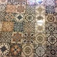 Tiled floor with various intricate floral and geometric patterns in earth tones.
