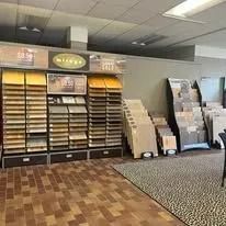 Shelves displaying tile samples in a store; interior.