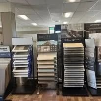 Tile displays inside a showroom, showcasing various colors and textures.