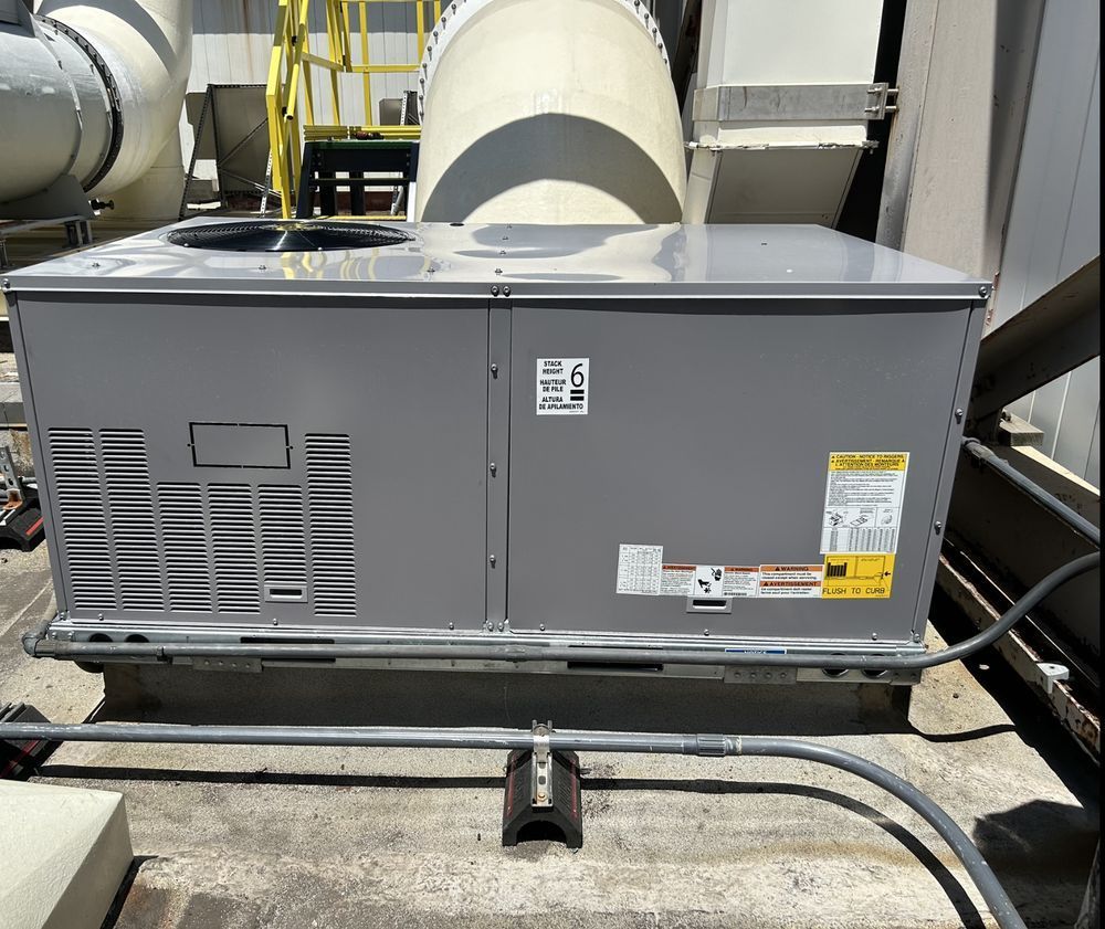 An air conditioner is sitting on the roof of a building.