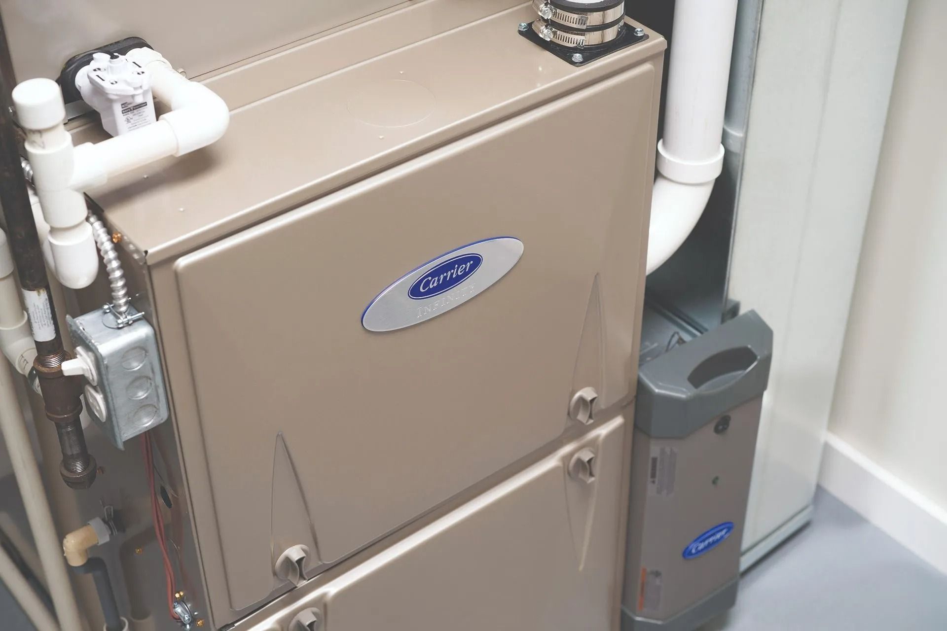 Beige Carrier furnace in a utility room.