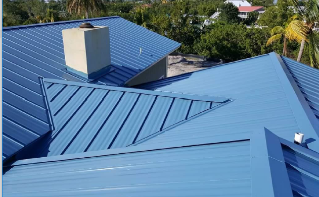 Blue metal roof with chimney, angled view.
