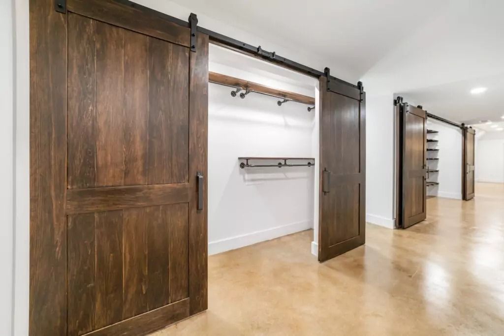 A hallway with sliding barn doors leading to a closet.