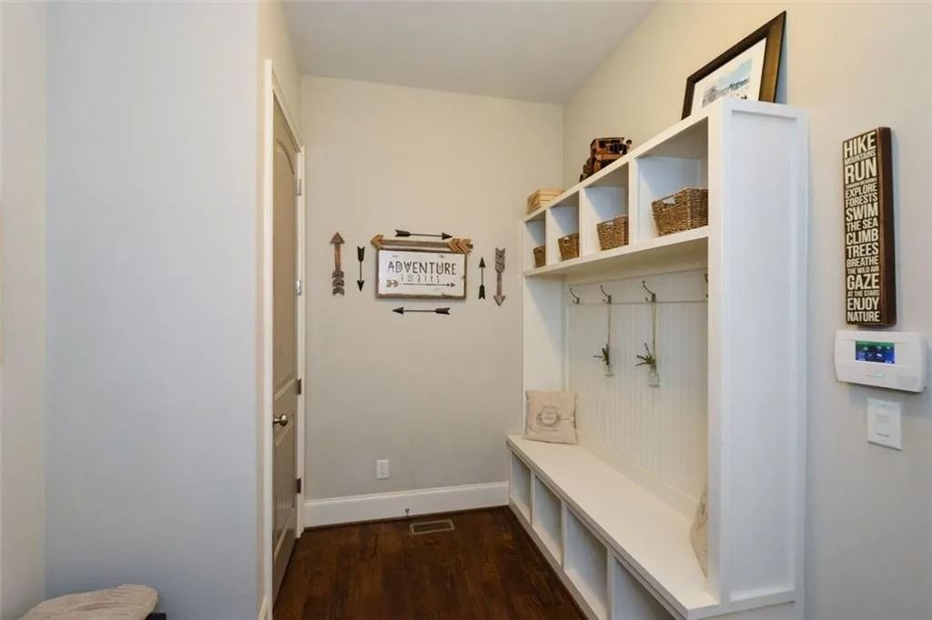 A hallway with a bench and shelves in it