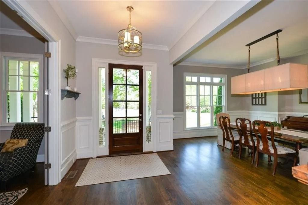 A living room and dining room in a house with hardwood floors