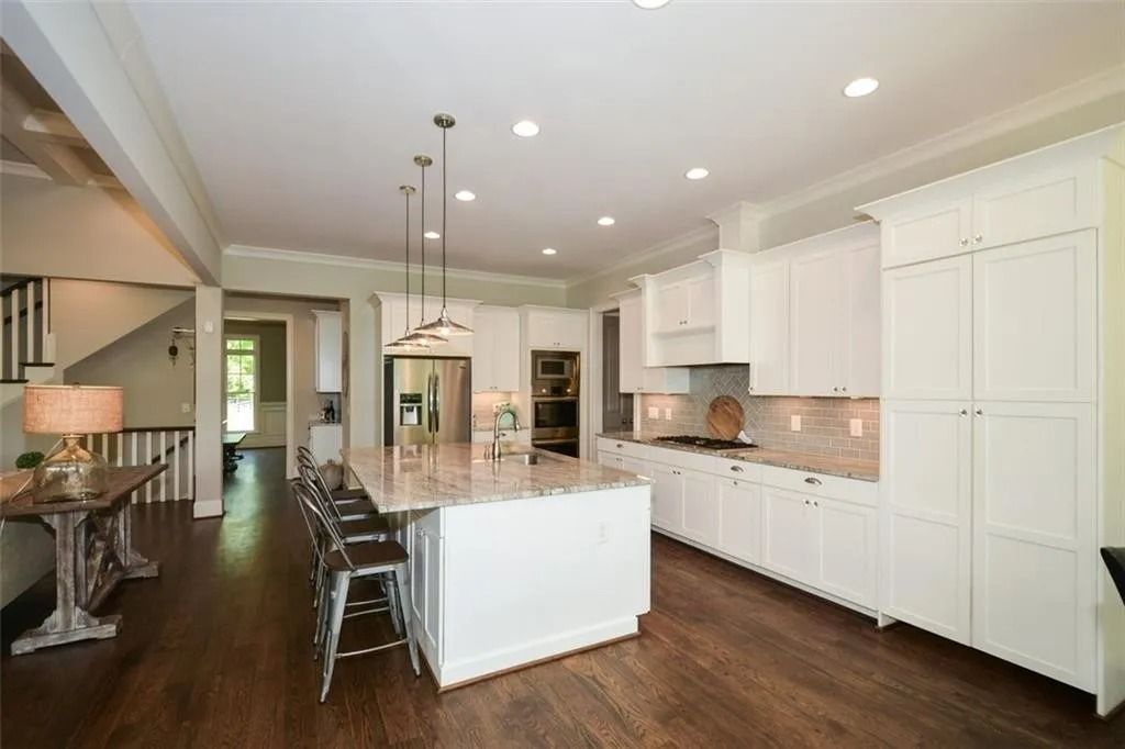 A living room and dining room in a house with hardwood floors