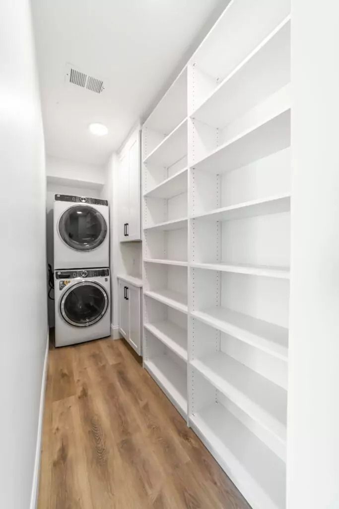 A laundry room with a washer and dryer stacked on top of each other.