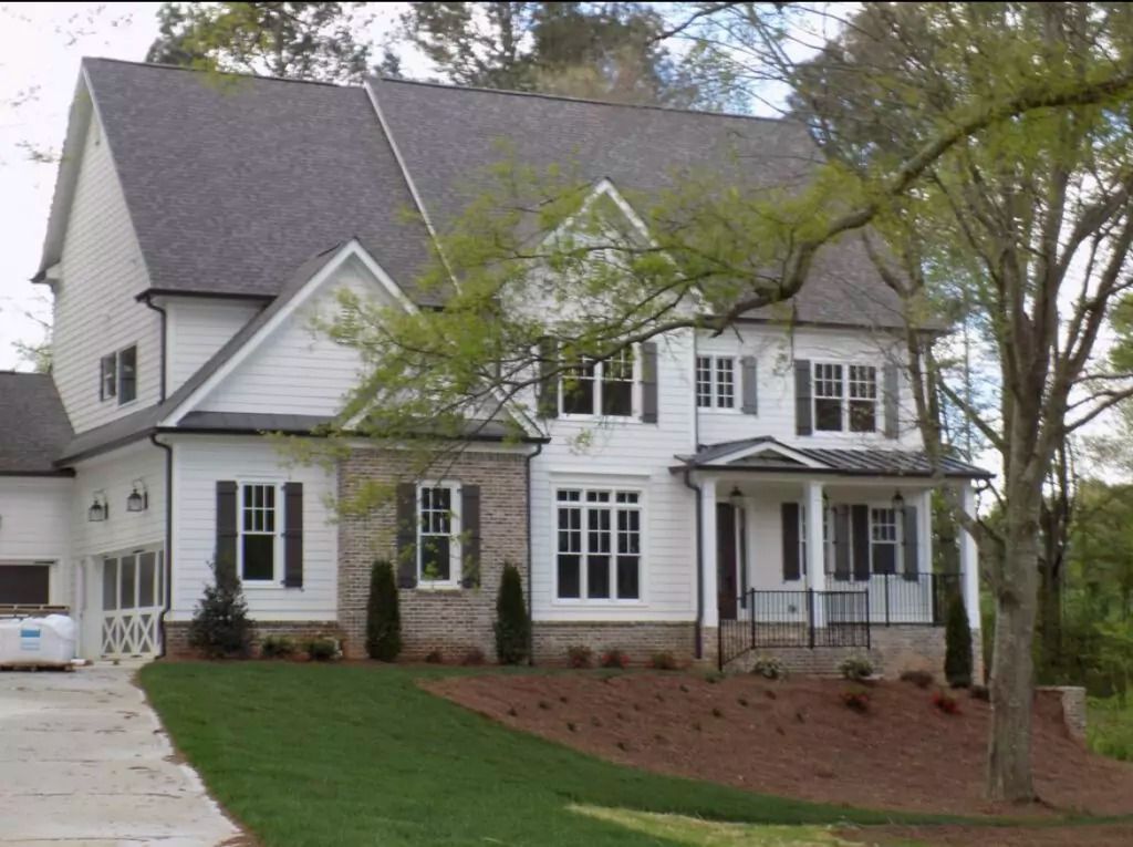 A large white house with a gray roof