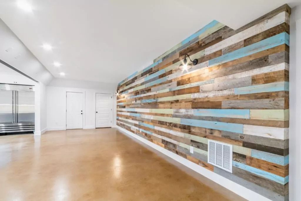 An empty room with a wooden wall and a wooden floor.