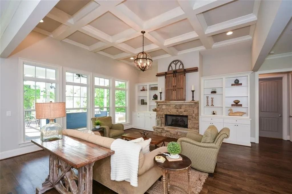 A living room with a coffered ceiling and a fireplace