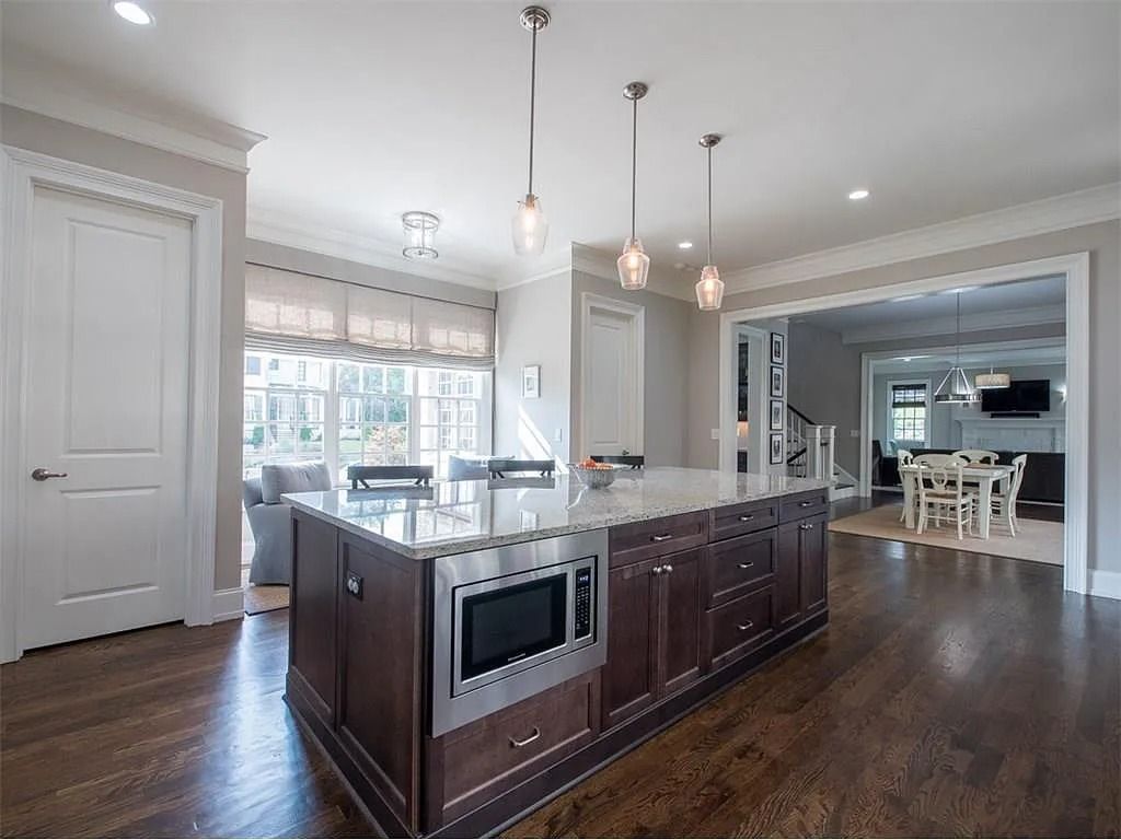 A kitchen with a large island and stainless steel appliances.