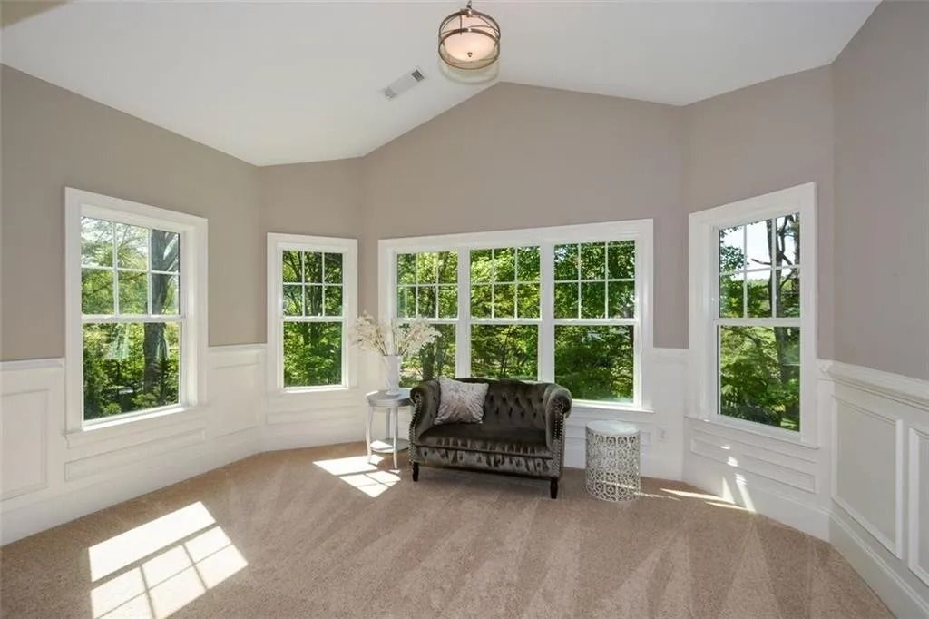 A living room with a couch and lots of windows