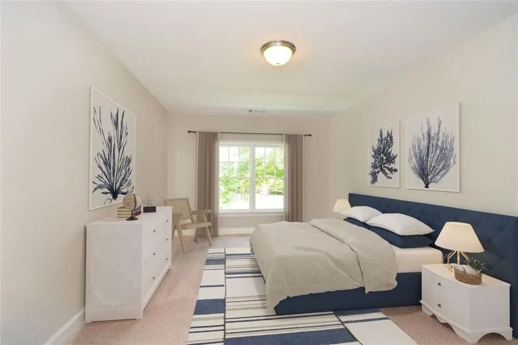 A bedroom with a large bed and a dresser
