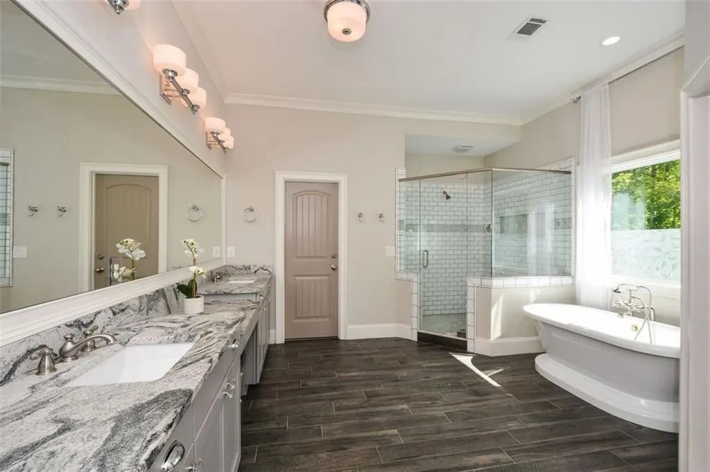 A bathroom with two sinks and a bathtub