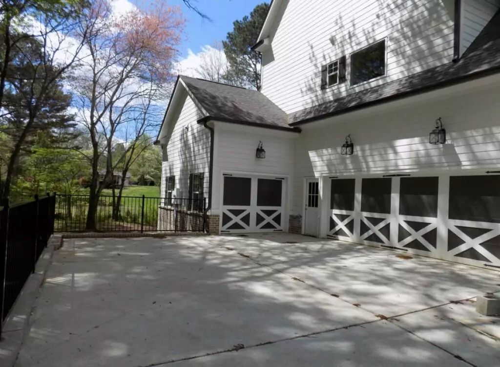 A large white house with a driveway leading to it