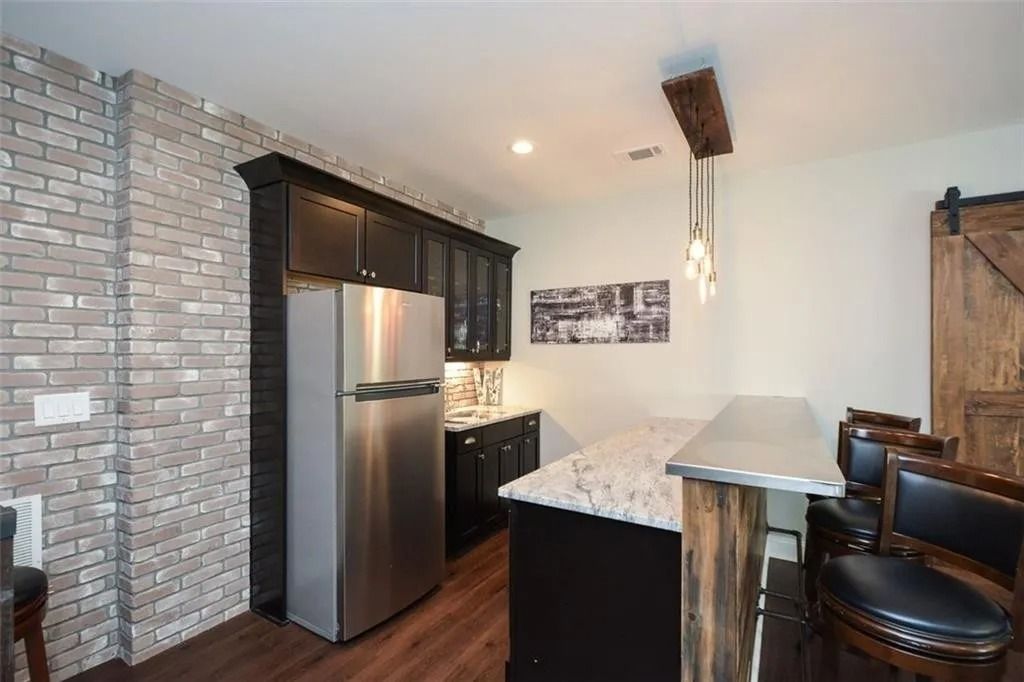 A kitchen with stainless steel appliances and a refrigerator