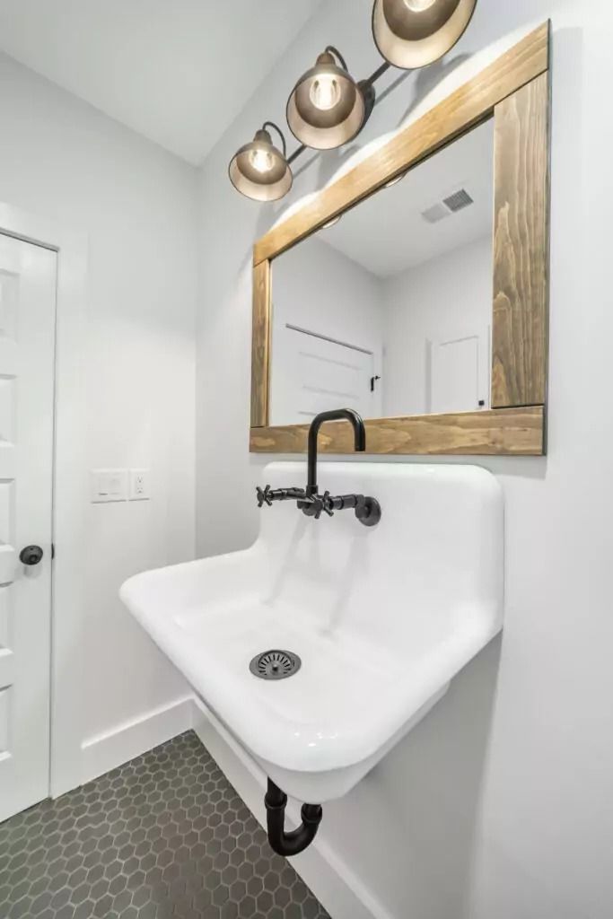 A bathroom with a sink and a mirror on the wall.
