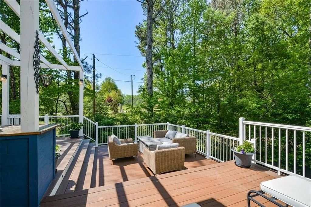 There is a large deck with a lot of furniture on it.