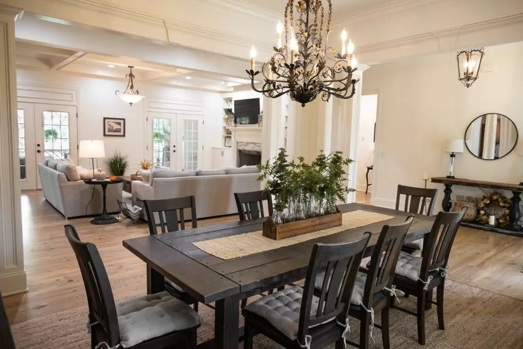 A dining room with a table and chairs and a chandelier