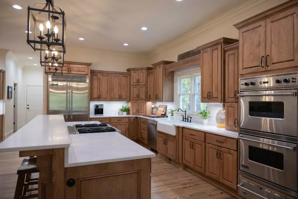 A large kitchen with wooden cabinets and stainless steel appliances.