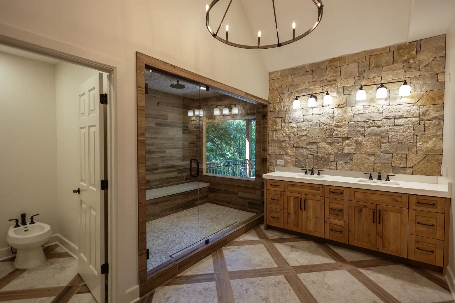 A bathroom with two sinks and a walk in shower.