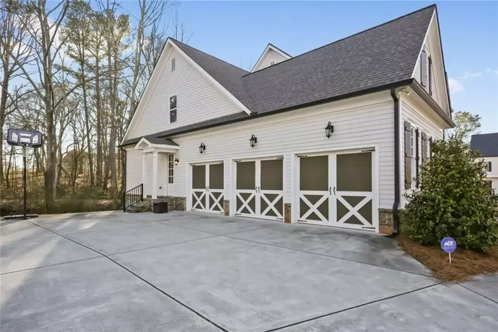 A large white house with a lot of garage doors