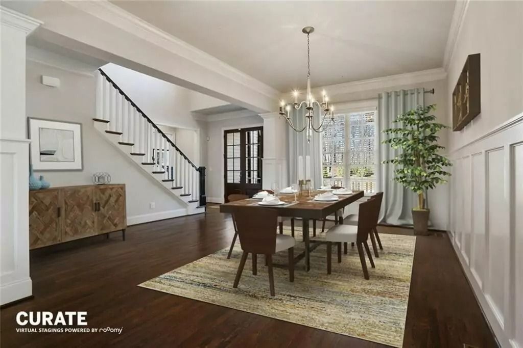 A dining room with a table and chairs and a chandelier.