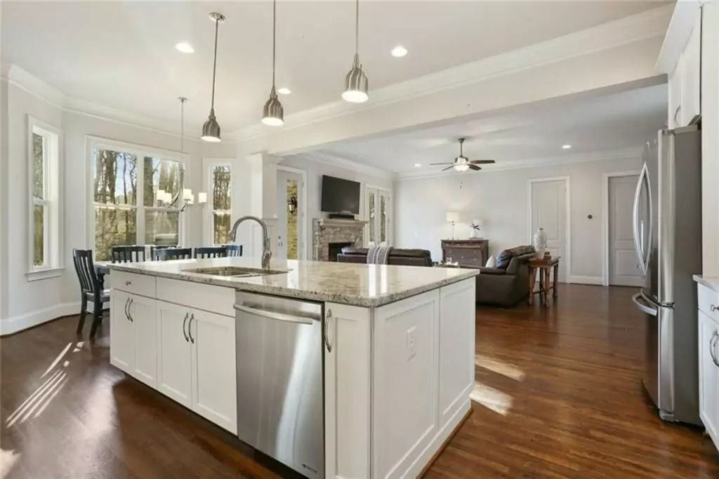 A kitchen with a large island and stainless steel appliances.
