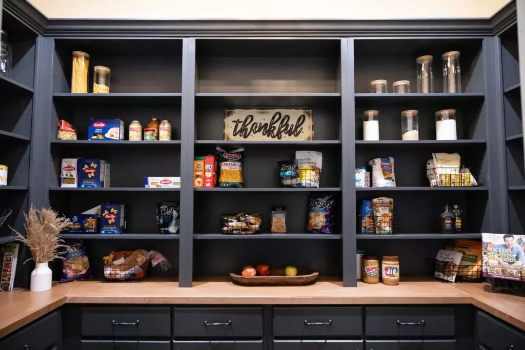 A pantry filled with lots of food and a sign that says thankful.