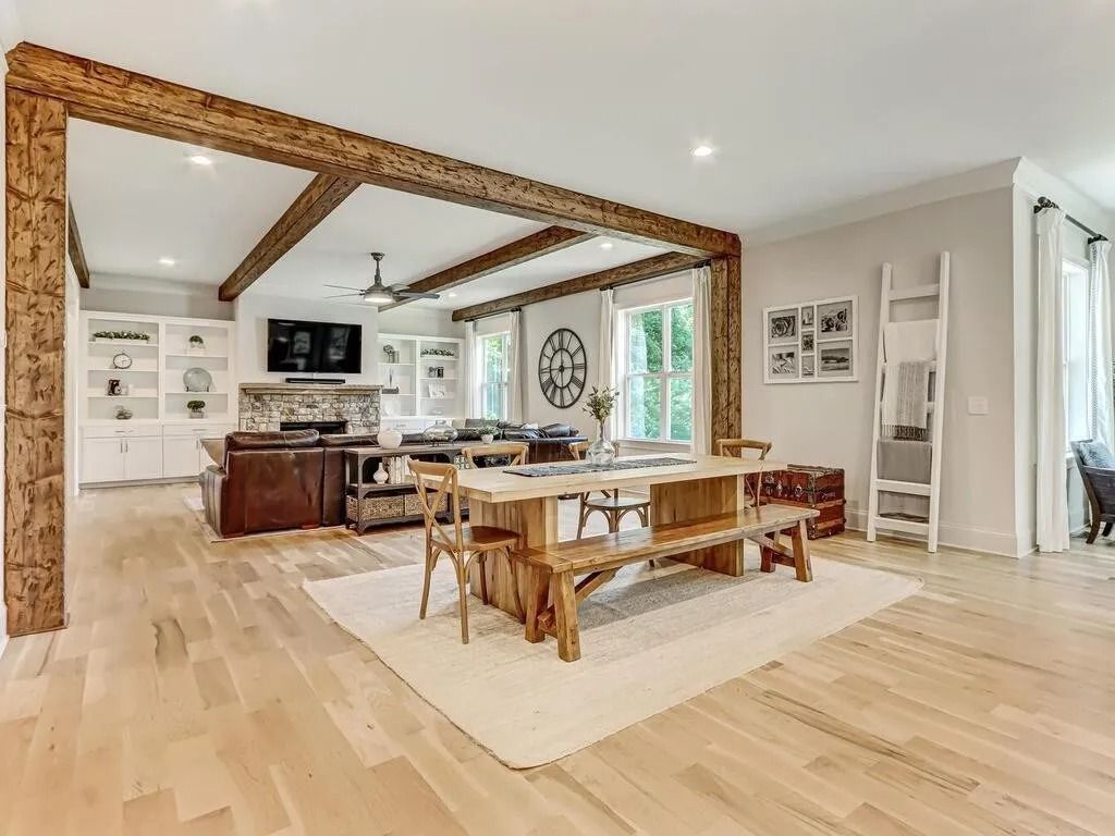 A large living room with a wooden table and benches.