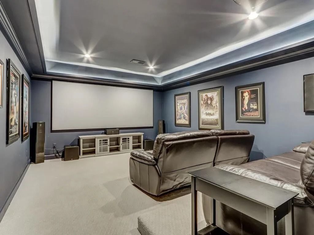 A home theater with a large screen and a couch.