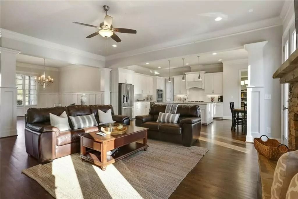 A living room filled with furniture and a ceiling fan.