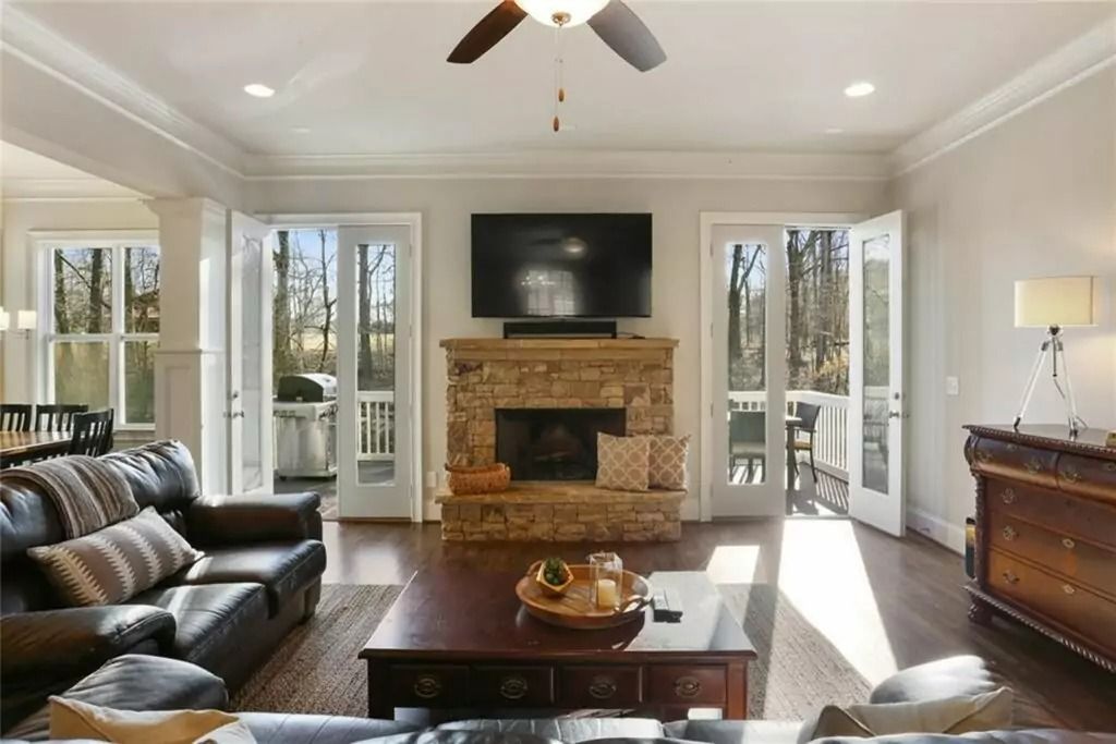 A living room with a fireplace and a flat screen tv
