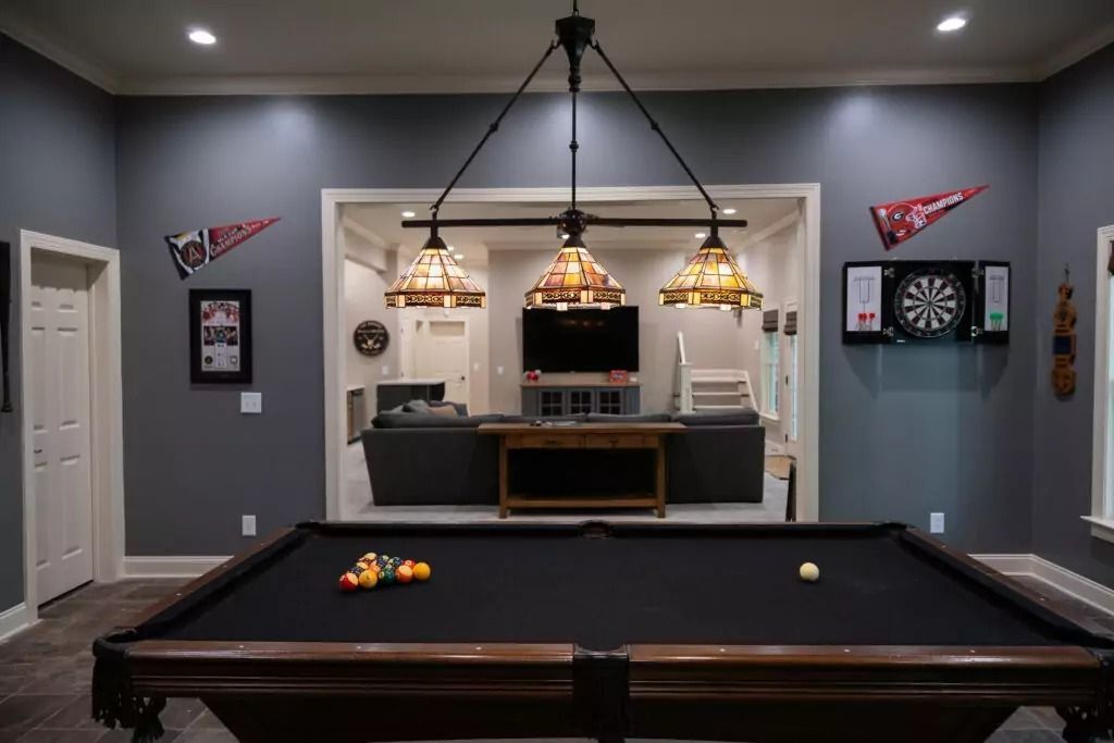There is a pool table in the middle of the room.